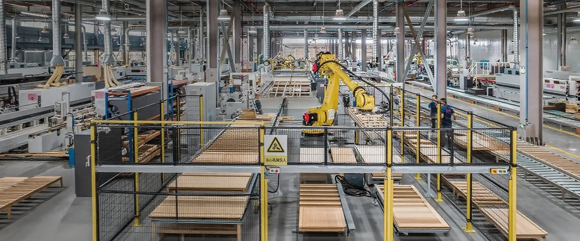 A spacious and well-organized Fujinzhai Furniture factory showcasing workers crafting wooden furniture pieces with natural light streaming through large windows.